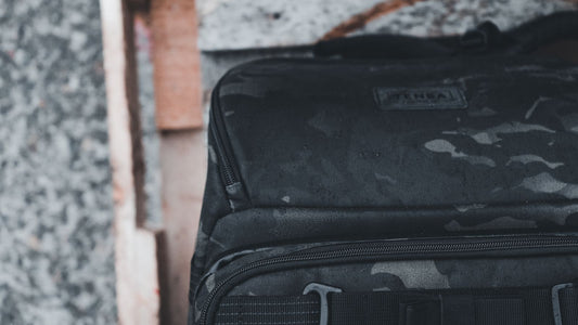 Camouflage tactical backpack in a rugged outdoor setting