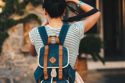 Young woman with a stylish backpack on a sunny city street