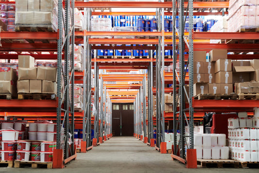 Rows of warehouse shelving stocked with boxes and pallets