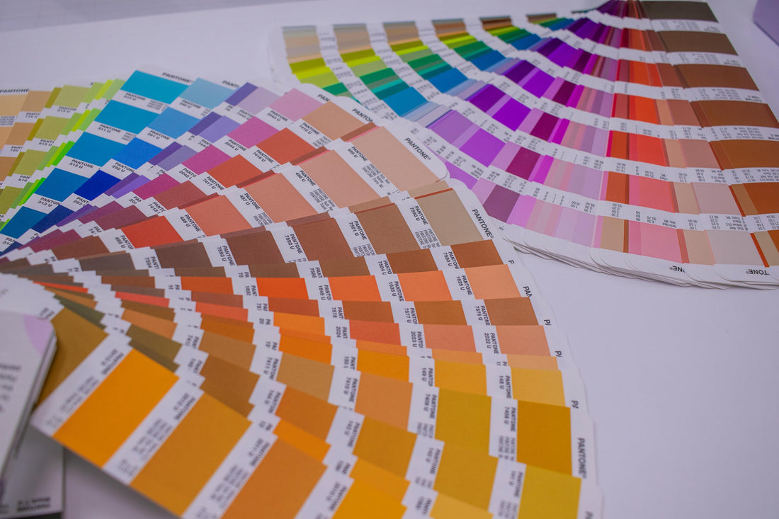 Fanned-out Pantone color swatch books used for backpack color matching
