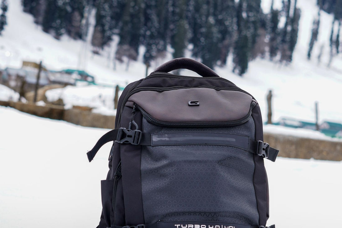 Outdoor backpack resting in a snowy landscape with forest background