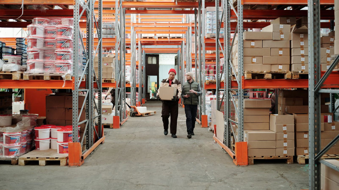 Two workers handling a package in a warehouse