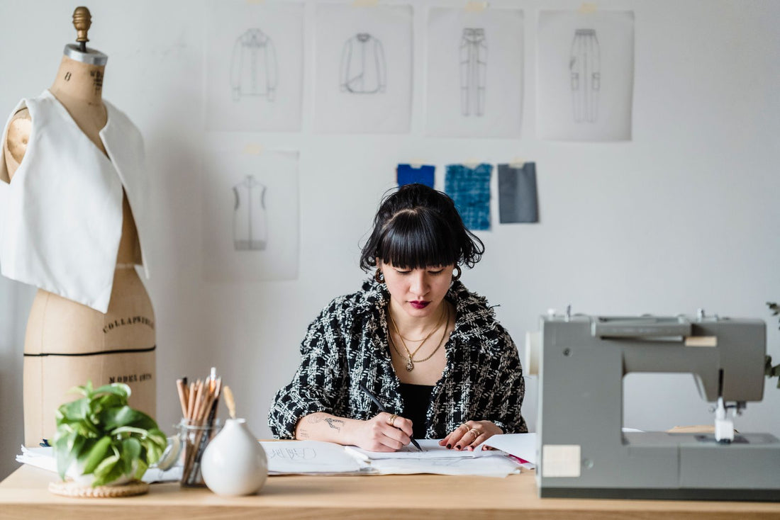 Designer drawing a product sketch at a studio workbench