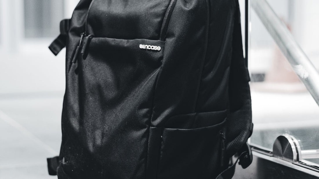 Stylish black backpack displayed on a polished retail floor