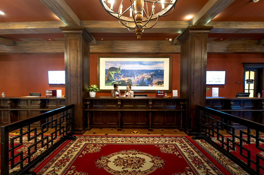 Hotel lobby front desk with staff assisting guests, an example hospitality setting
