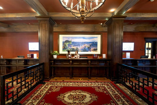 Hotel lobby front desk with staff assisting guests, an example hospitality setting