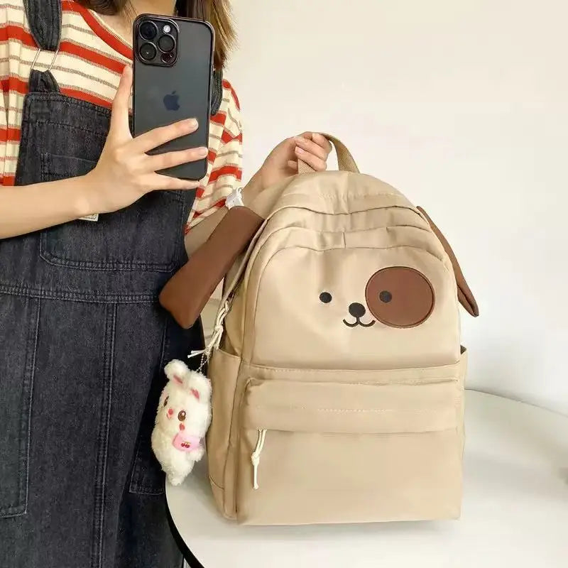 Amber cute cartoon backpack in khaki, held by model