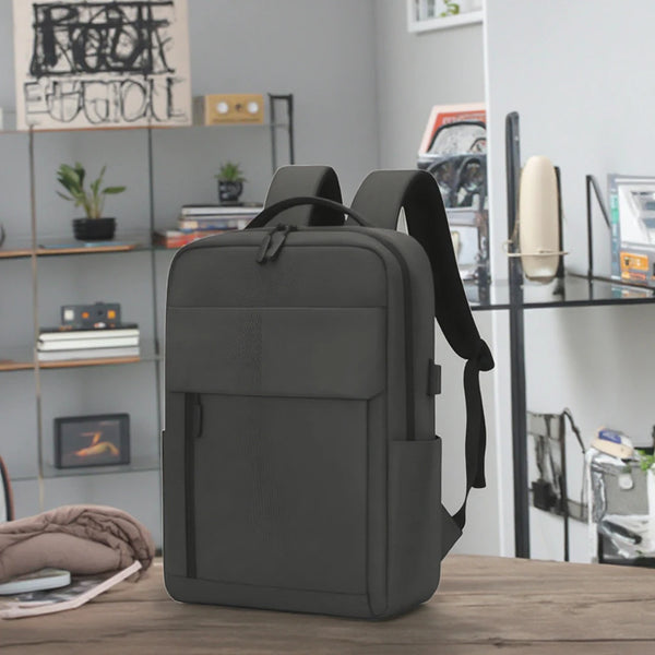 Euporie waterproof Oxford laptop backpack, charcoal, on a desk